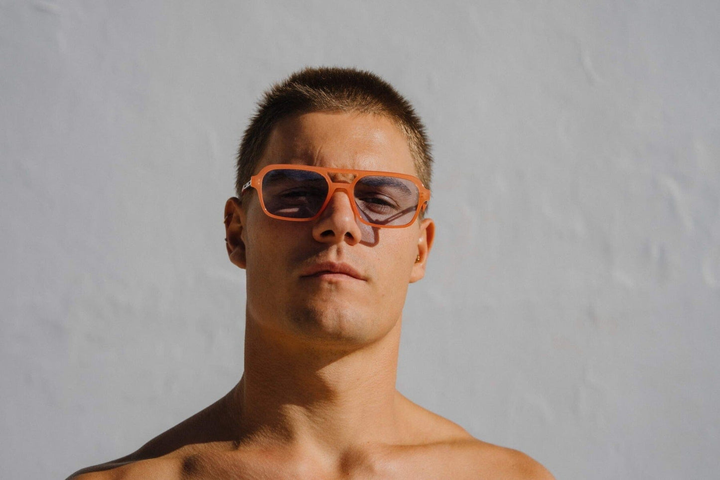 Aviator sunglasses. Blue lenses. Orange frames.