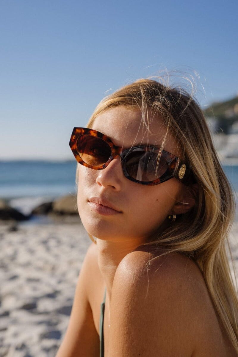 Gold and brown sunglasses. UV400 protected. Gold embellishment.