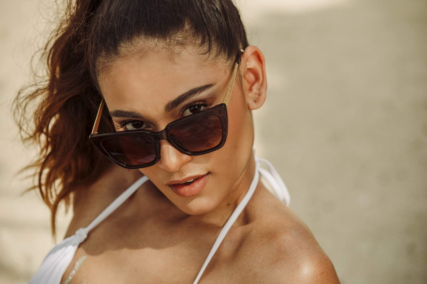 Gold cat eye sunglasses. Brown frames. Gold sparkly arms.