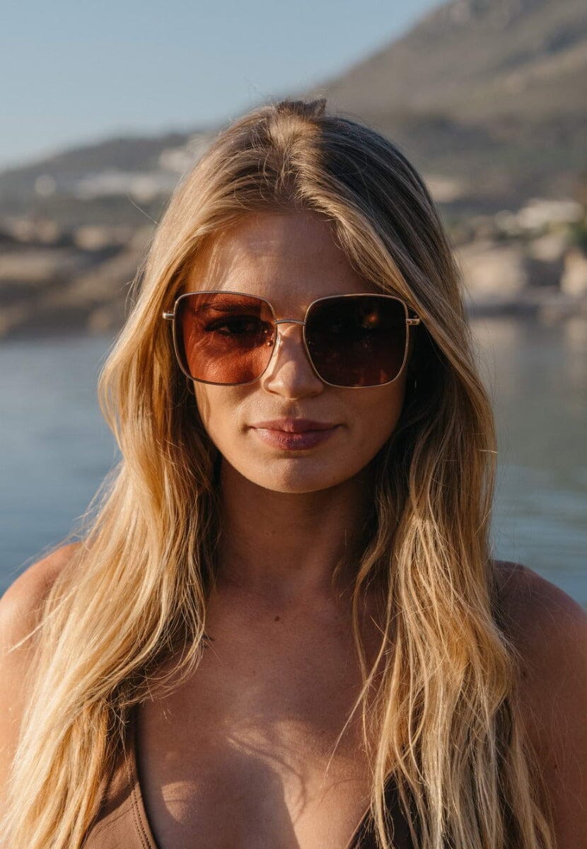 Square gold sunglasses. UV400 protected. Brown lenses. Gold frames.