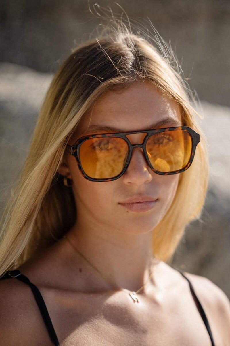 Large framed aviator sunglasses. Orange lenses. 100% UV protected.